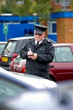 A Civil enforcement officer writing a ticket
