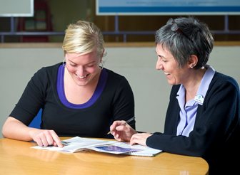 A customer services representative talking to a member of the public