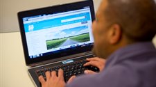 A photograph of a man searching the council website