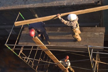 Builders working on a scaffolding platform.