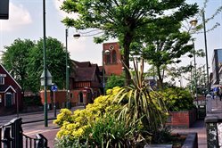 View of houses, trees and a road on Borehamwood High Street