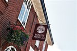 Exterior of the Bushey Museum building and sign