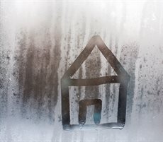 Outline of a house on a window with condensation.