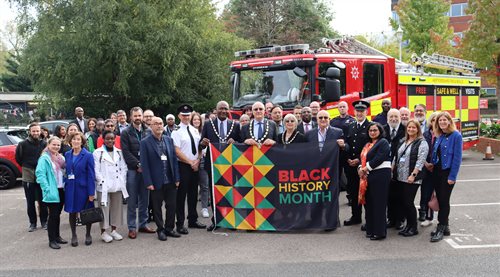 Representatives with the Black History Month flag.