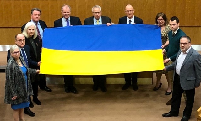 Leaders of the district and borough councils with PCC David Lloyd hold the Ukraine flag in the council chamber.