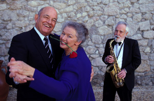 An older couple dance together