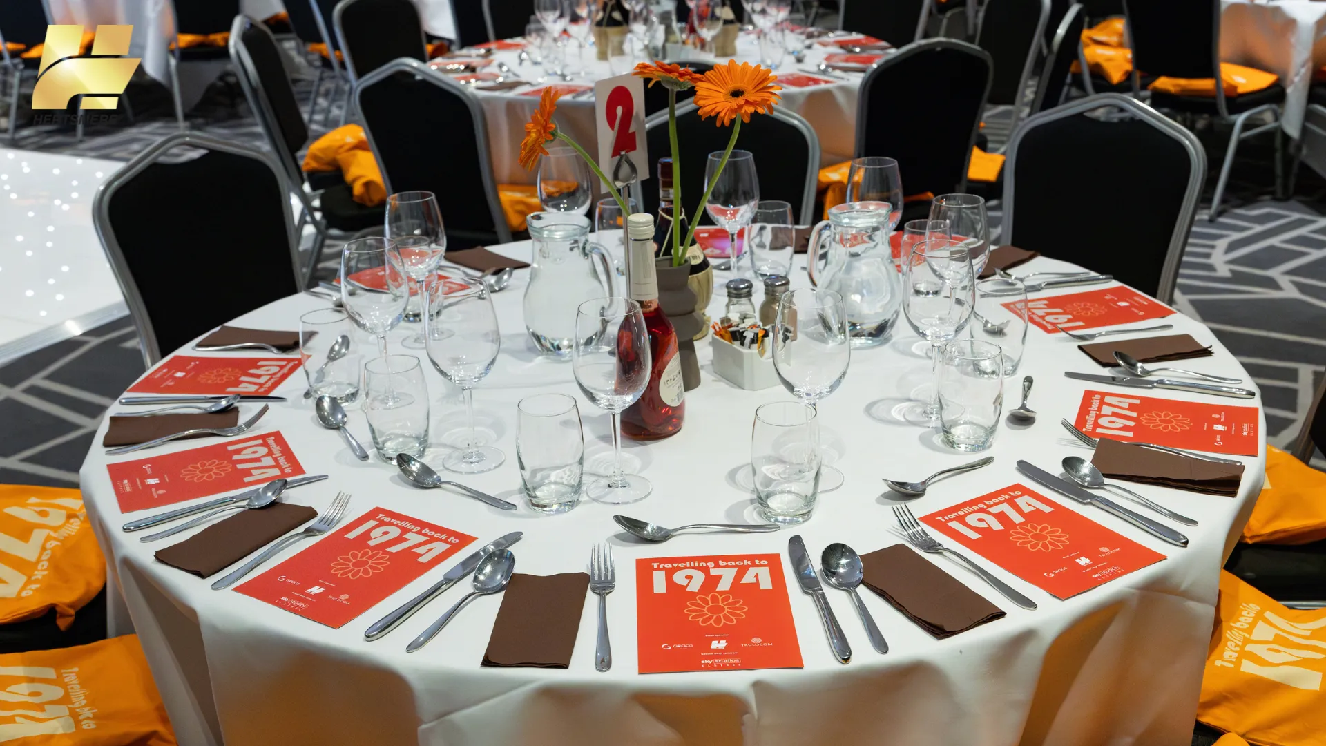 Round Table set for the 50th Anniversary Celebration Dinner, complete with glasses and cutlery.