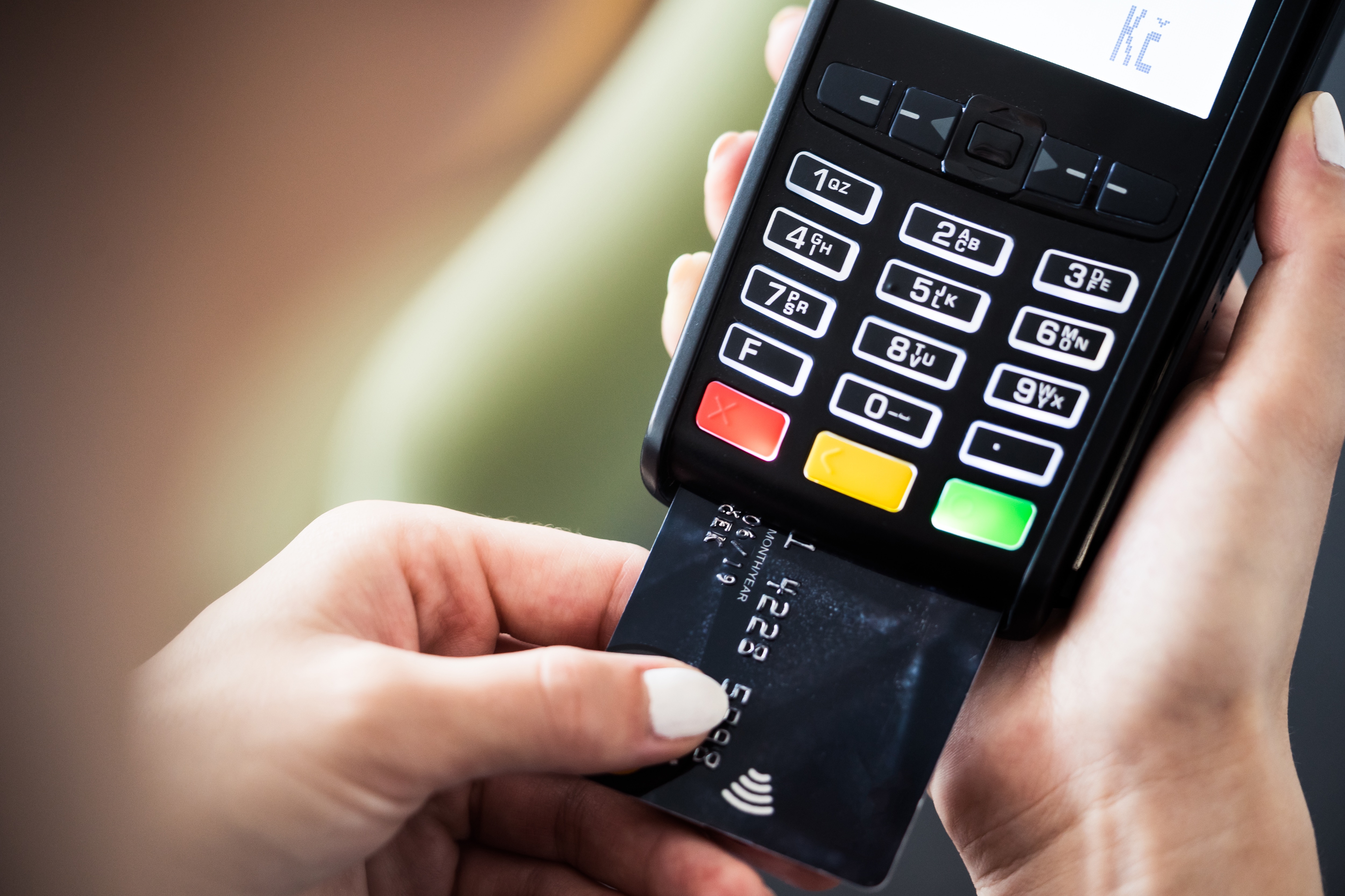 Credit card payment machine with person inserting a card