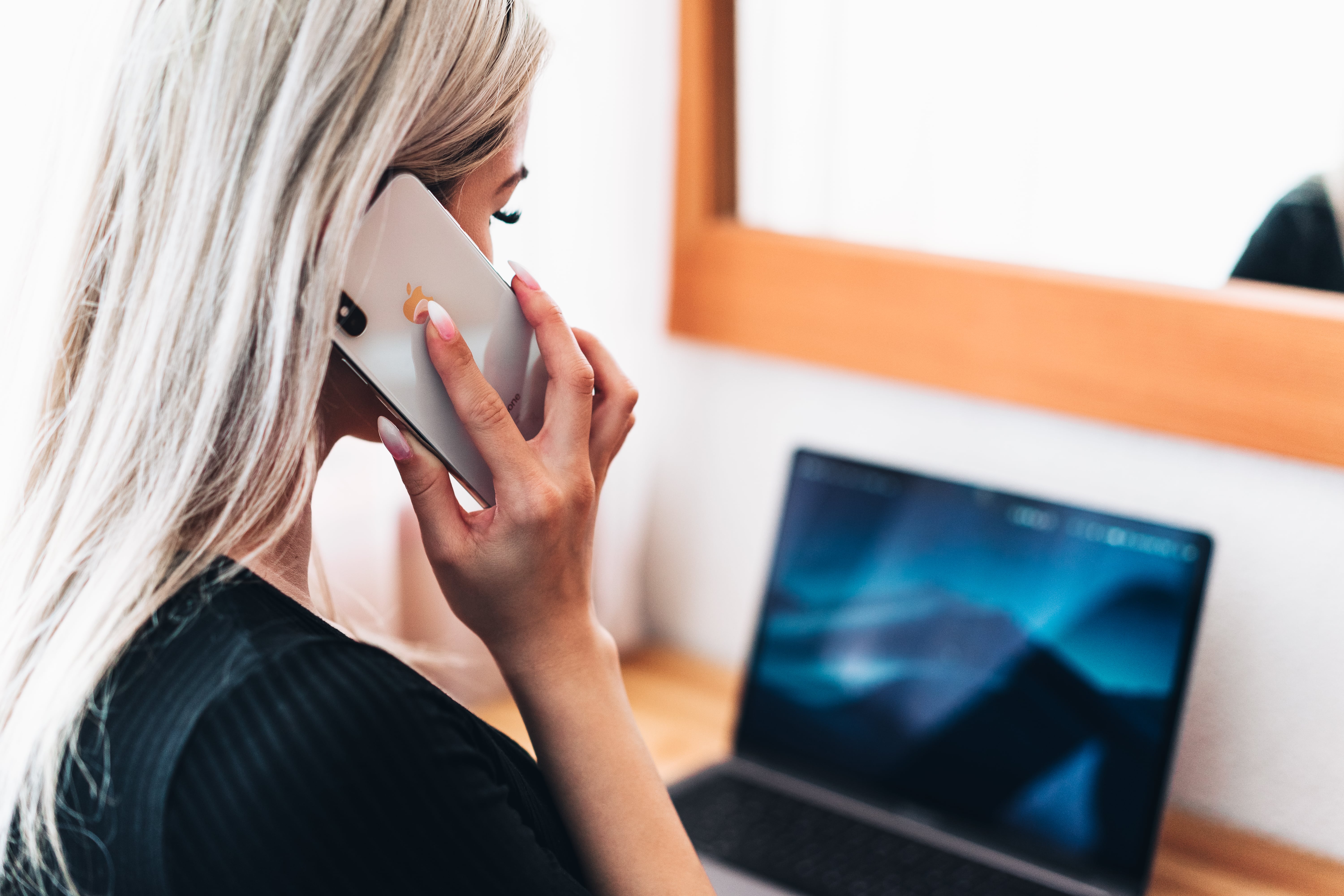 Lady on the telephone and using her laptop