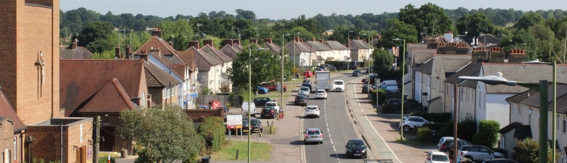 Aerial view or moving and parked vehicles on a road