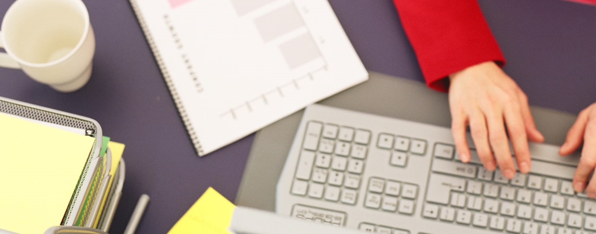 Person using a computer keyboard at a desk