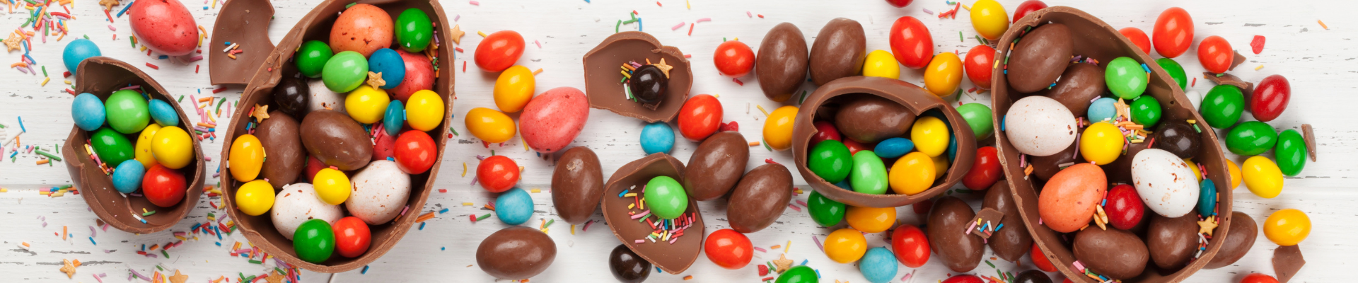 Chocolate eggs smashed open with multicoloured chocolate eggs inside