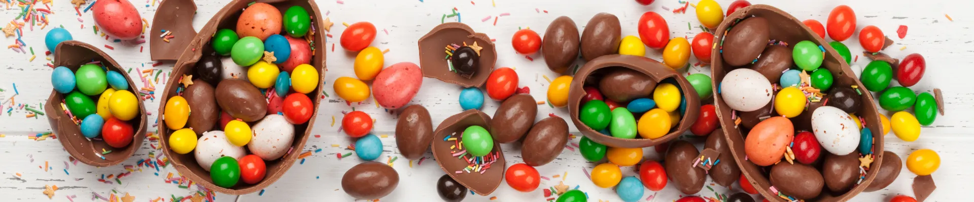Chocolate eggs smashed open with multicoloured chocolate eggs inside