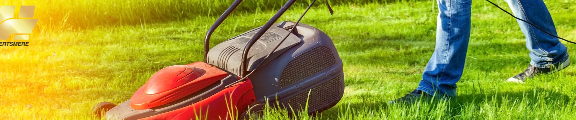 person pushing lawnmower, cutting grass