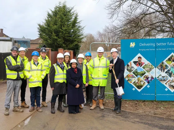 Group in high visibility vests assembled outside building site