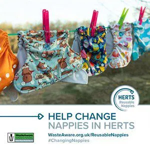 A row of nappies hanging on a washing line to promote reusable nappies.