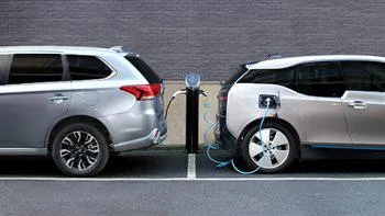 Two cars charging at charging points.