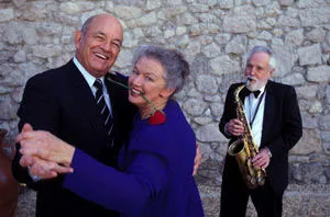An older couple dance together