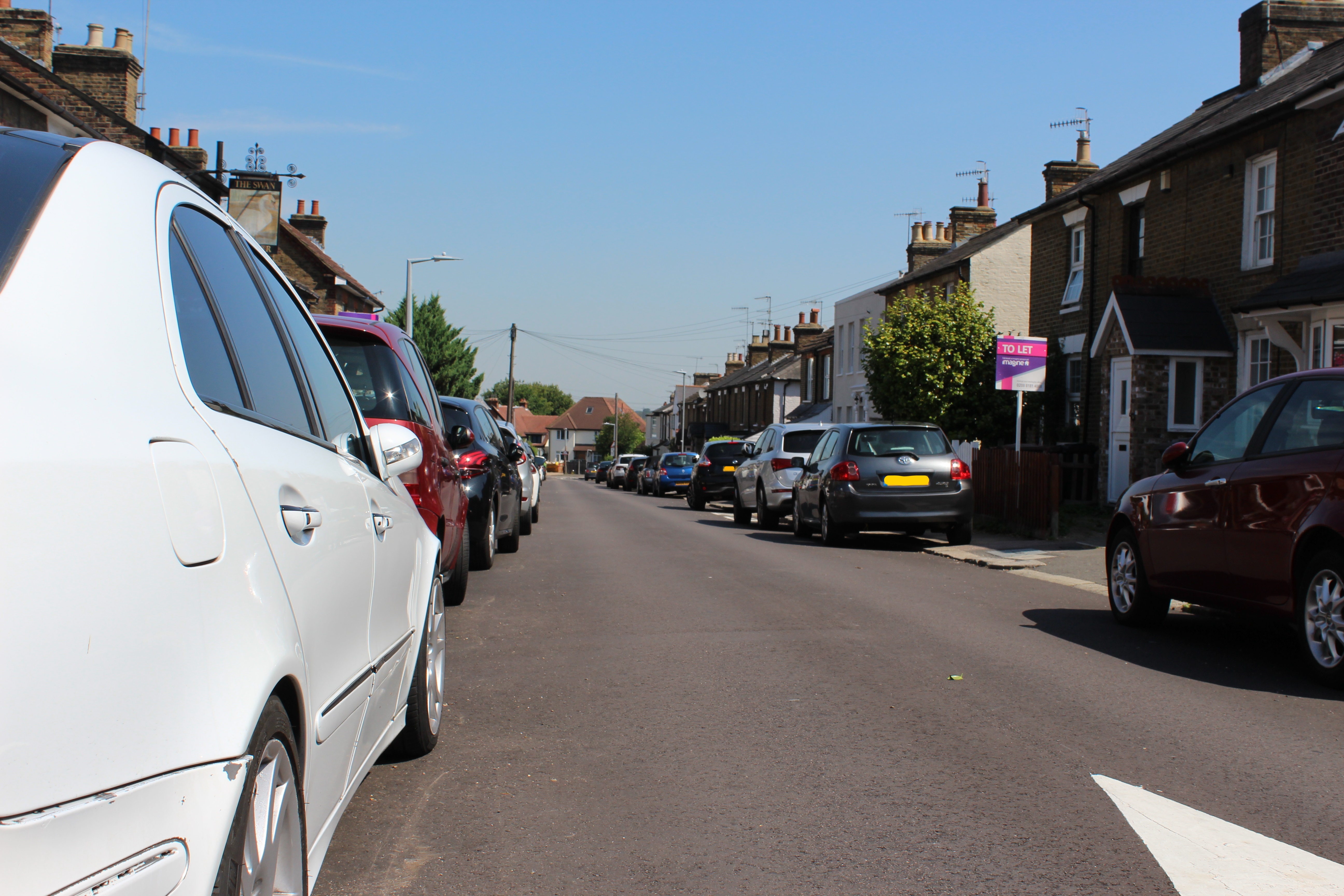 Cars parked on both sides of a residential road