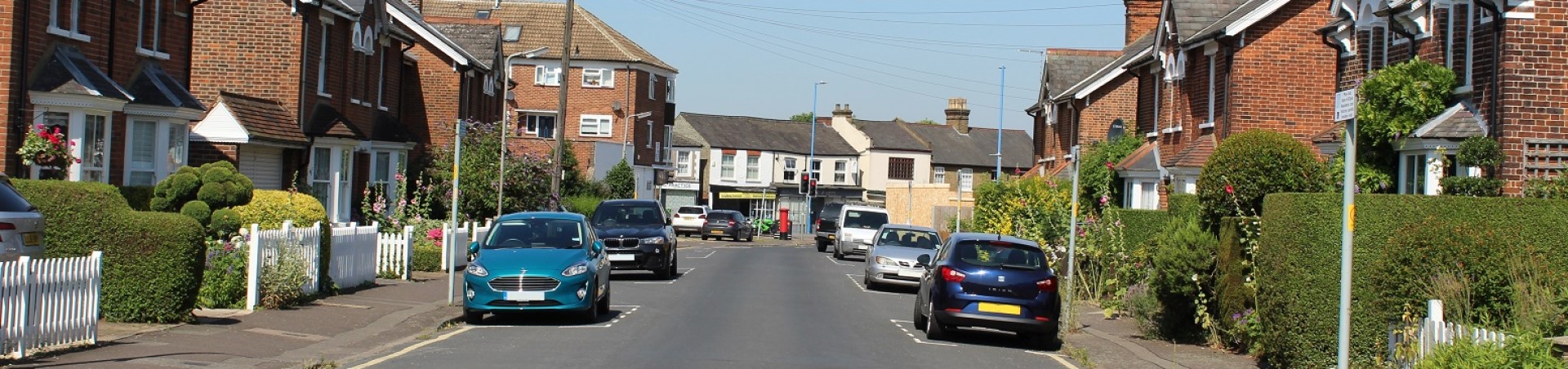 Residential road with painted zones for parking vehicles