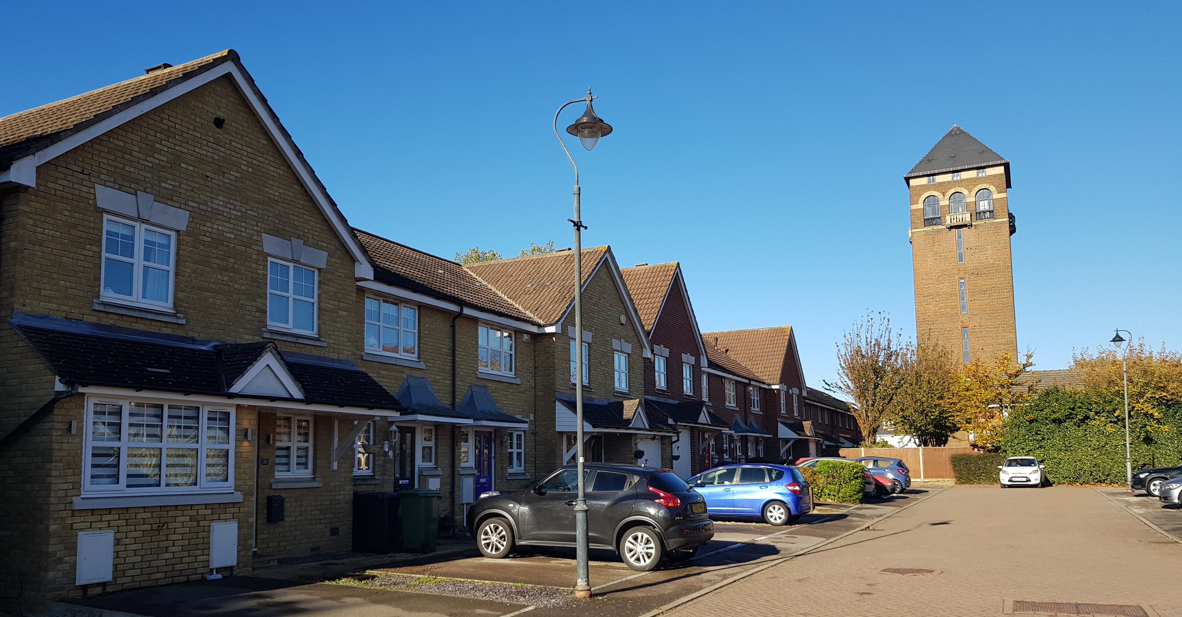 row of houses and cars parked on driveways